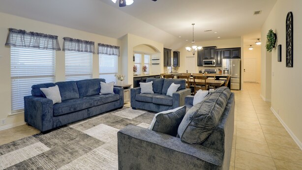 A spacious living room with two sofas, a coffee table, and a ceiling fan. - 6 Mi to Dtwn Mansfield! Family Getaway w/ Patio (Mansfield)