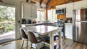 A modern kitchen with white cabinets, stainless steel appliances, and a large island. - Cozy & Chic Lake Arrowhead Cabin w/ Deck! (Lake Arrowhead)