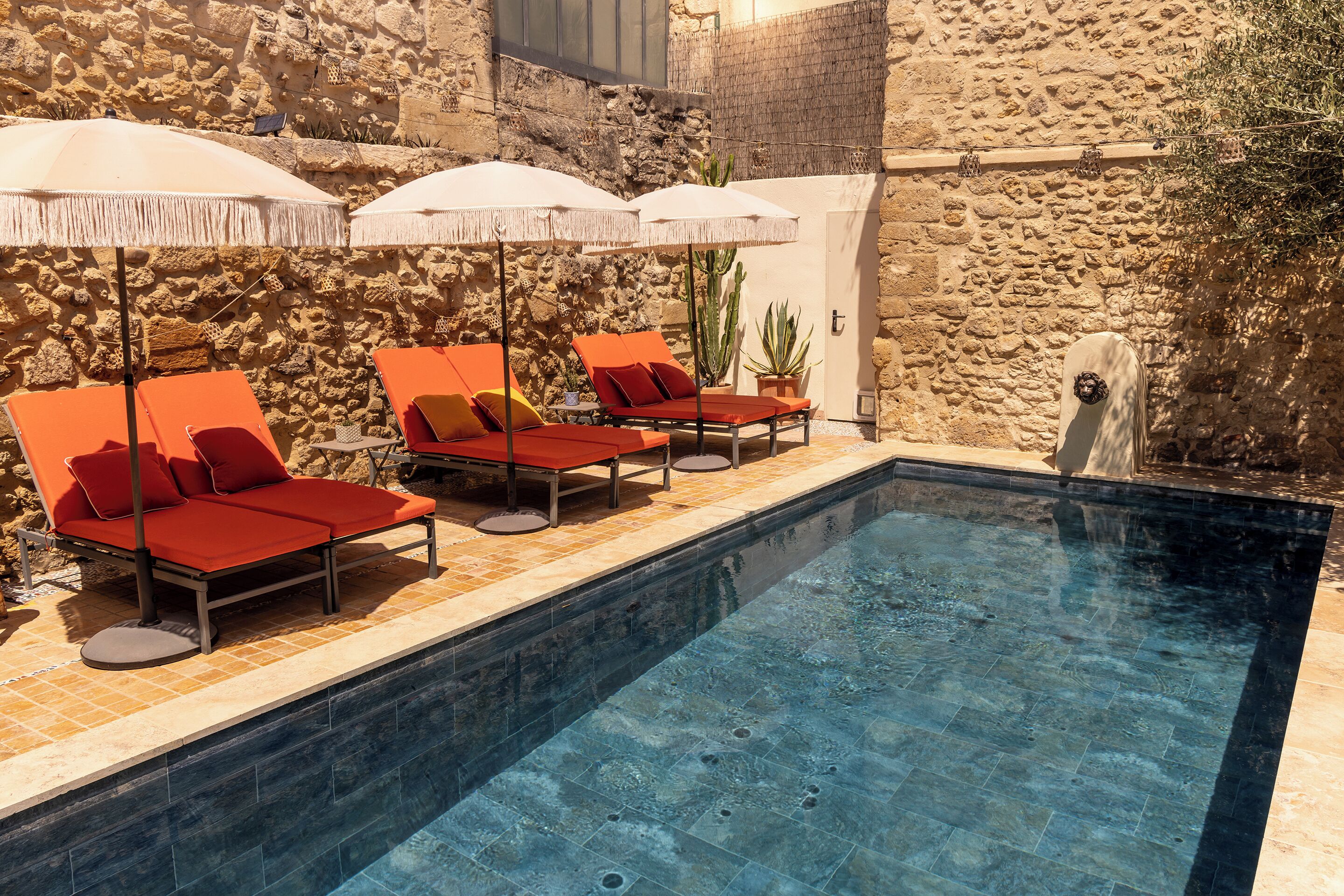 Seasonal outdoor pool, open 10:00 AM to 8:00 PM, pool umbrellas