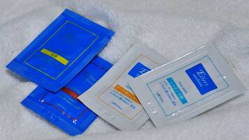 A collection of skincare products on a white towel.