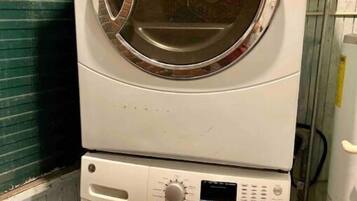 A stacked washer and dryer unit in a laundry room.