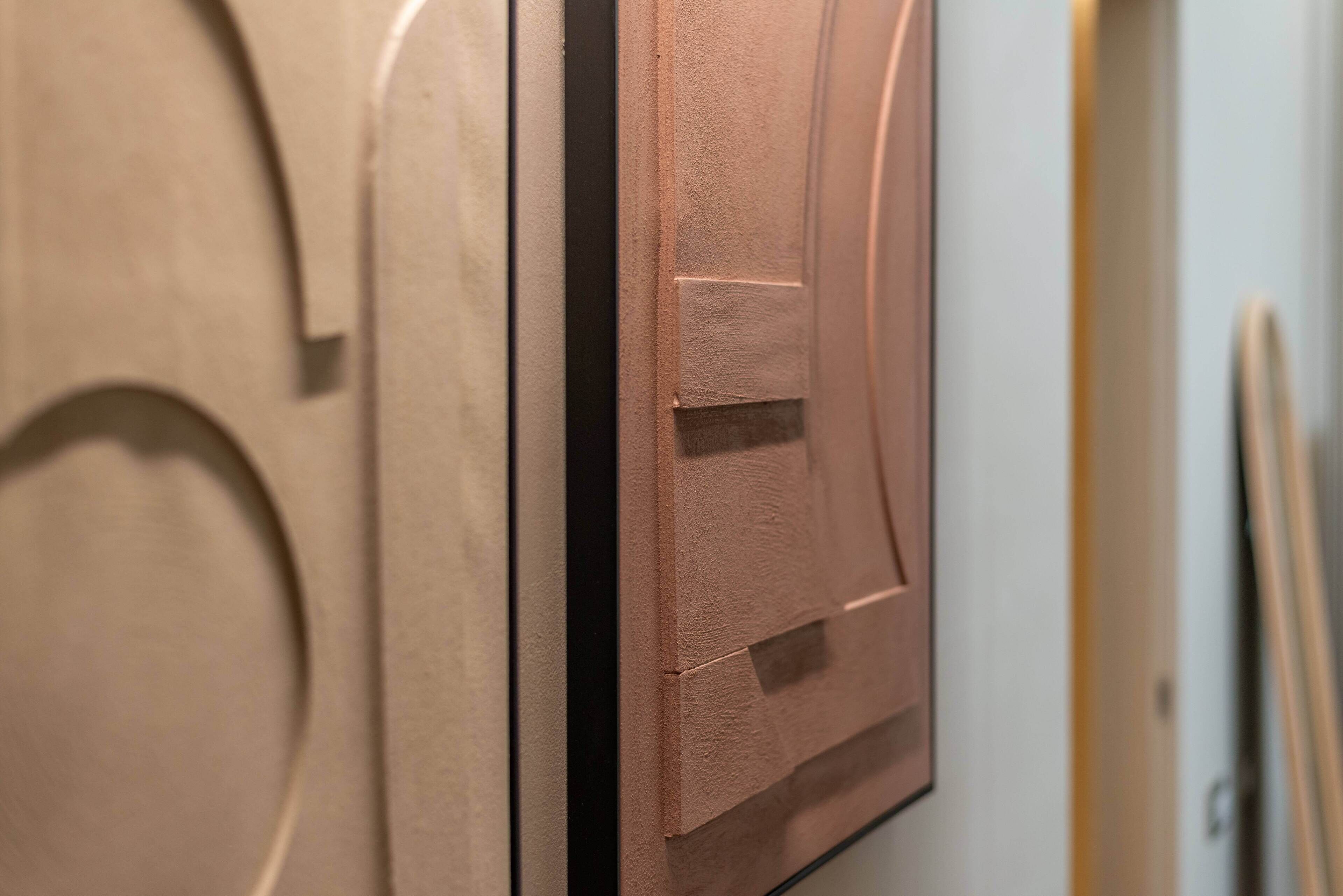 A close-up of a wooden door with a textured surface and a rectangular panel.