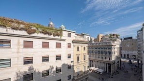 A historic square with classical architecture, including columns and a domed building. - Duomo Collection (Milan)