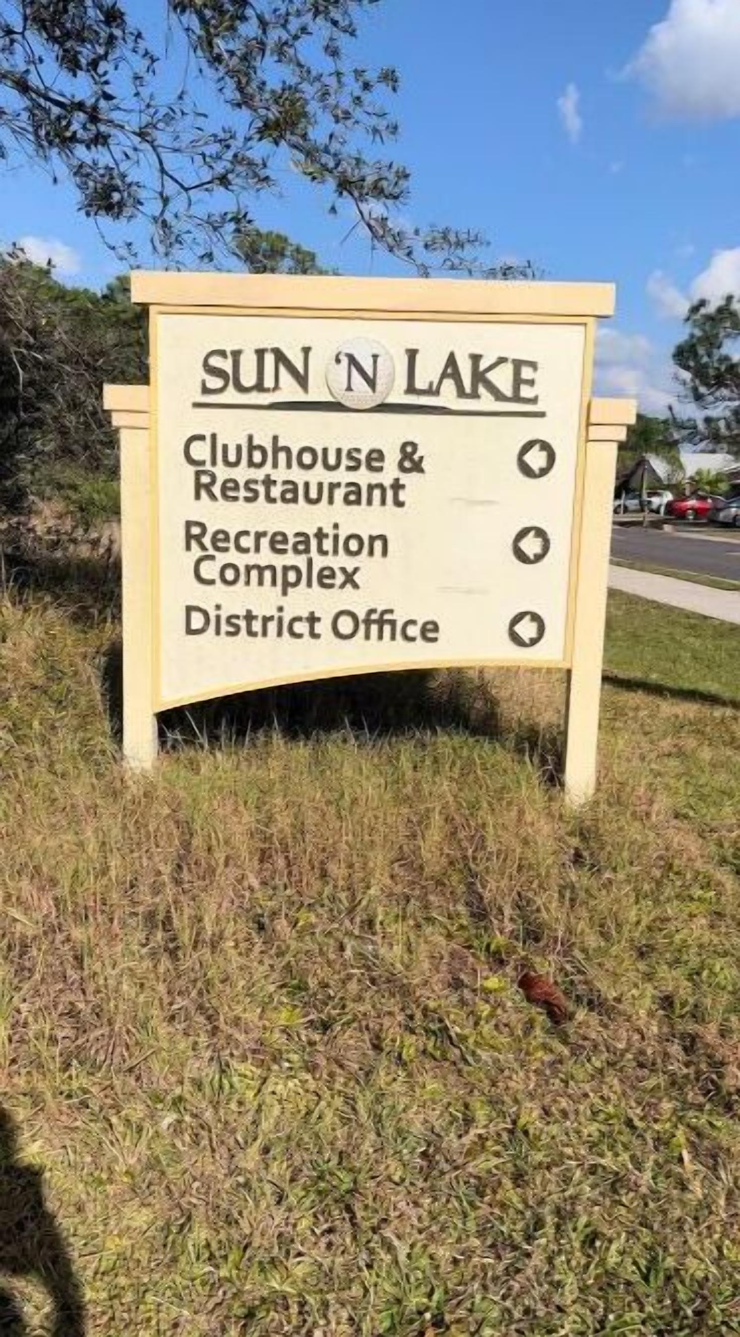 A sign listing SUN 'N LAKE Clubhouse & Restaurant, Recreation Complex, and District Office.