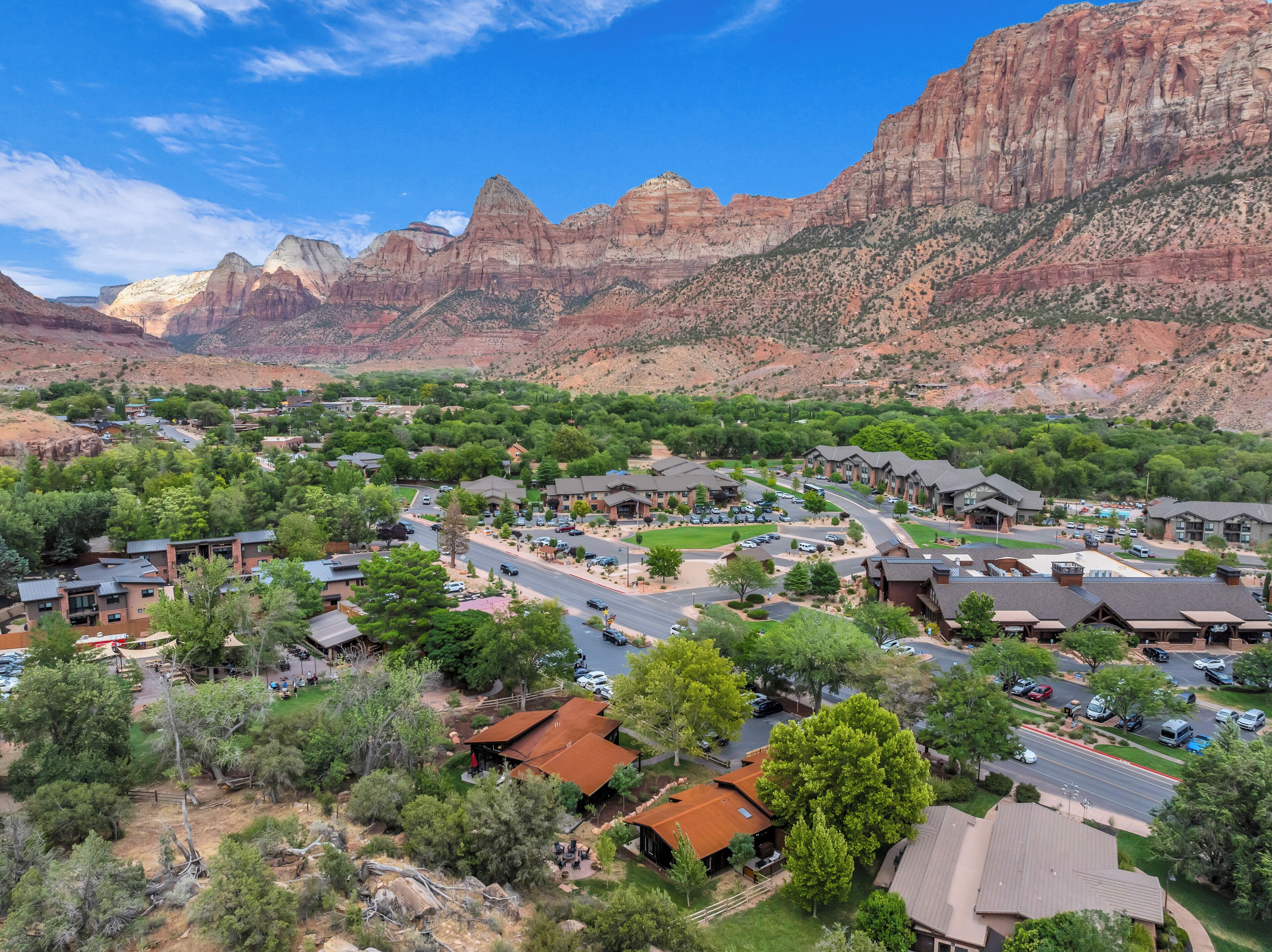 A residential area with houses, roads, and a mountainous backdrop.