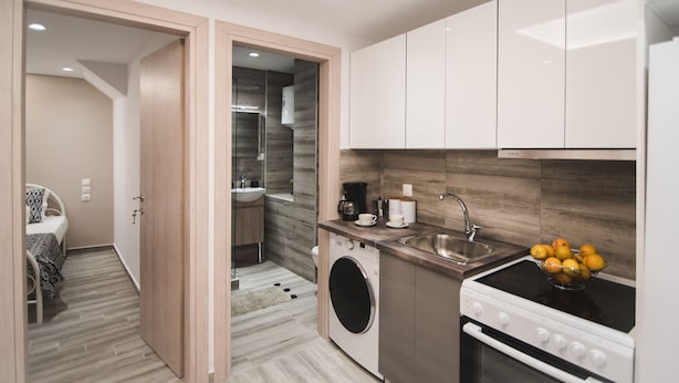 A compact kitchen with a washing machine, a stove, and a sink. - Contemporary Studios Historic Center (Corfu)