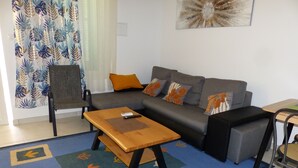 A living room with a sofa, a coffee table, and a chair.