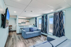 Family Suite | Living area | 55-inch Smart TV with cable channels