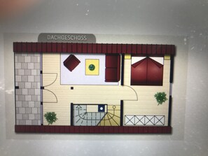 A floor plan of a hotel with a kitchen, dining area, and a living room. - Ferienhaus Nordsee-koje mit Meerblick, Strandkorb, Kamin, Sauna (Wangerland)