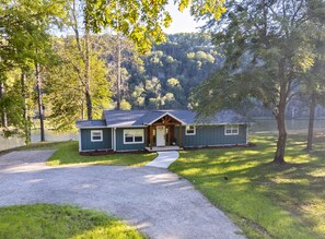 A single-story house with a front porch, a driveway, and a lawn. - NEW LISTING- Riverfront / Unique / Perfect location/ Private  (Lakeview)