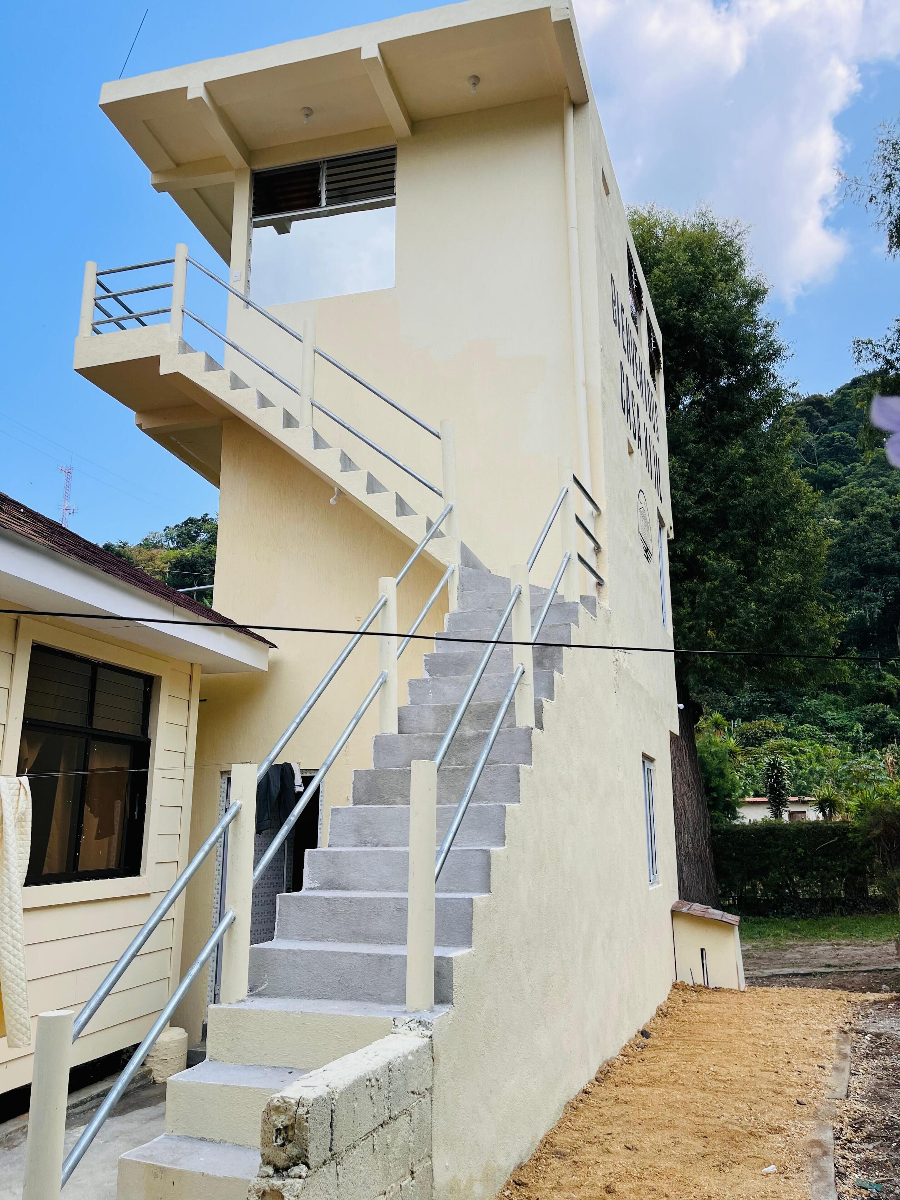 A multi-level building with a staircase and a small balcony.