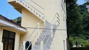 A multi-level building with a staircase and a small balcony.