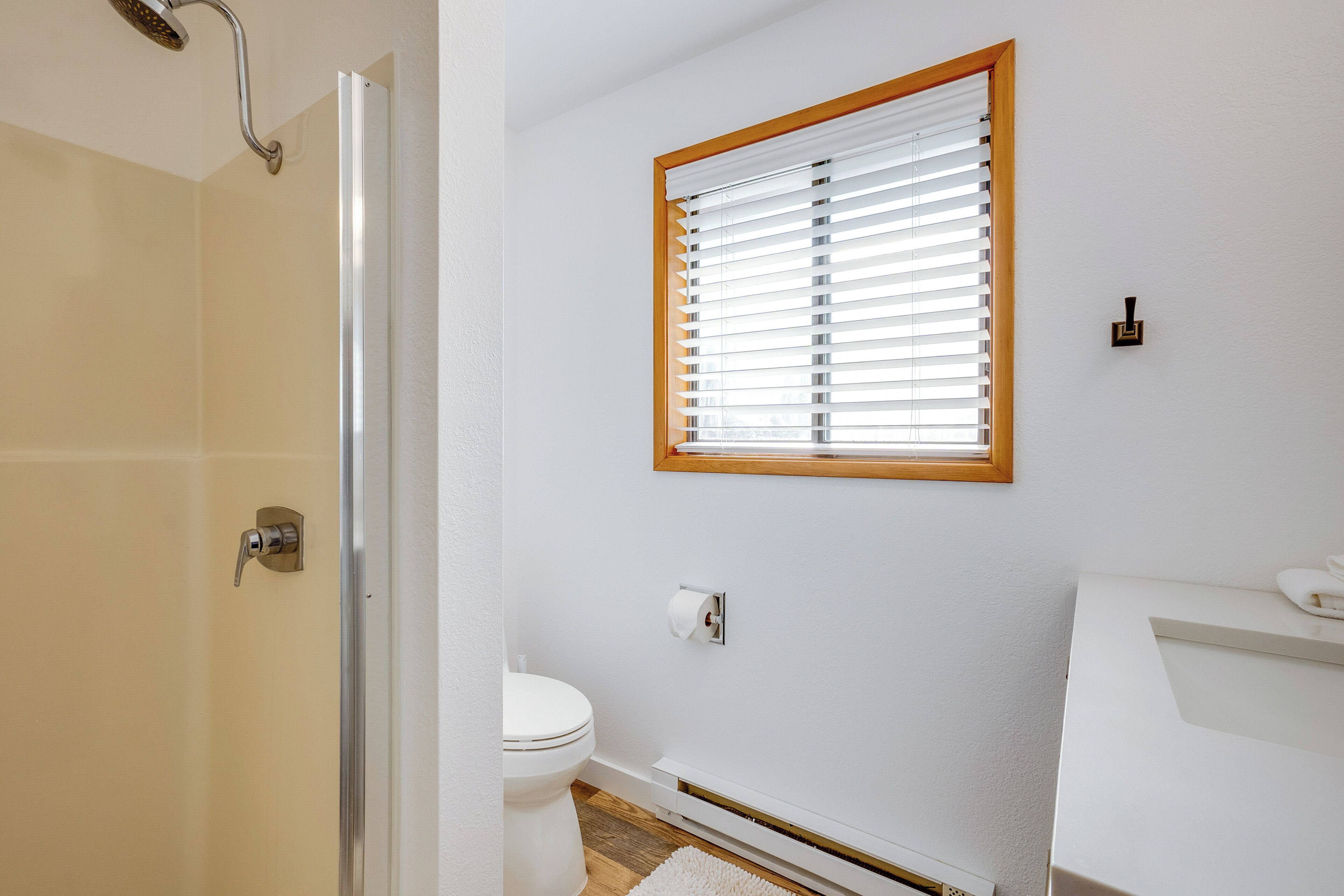 A bathroom with a shower, toilet, and sink.