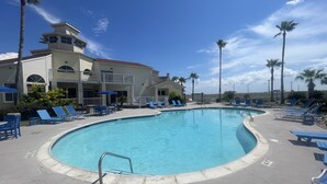 A pool area with lounge chairs and a no diving sign. - Beachfront Condo on Mustang Padre Island (Corpus Christi)