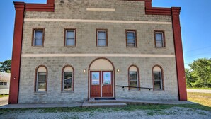 A two-story building with a symmetrical facade, featuring a central entrance with double doors and a small porch. - 2 Mi to Ice Caves: Pet-friendly Eben Junction Apt (Eben Junction)