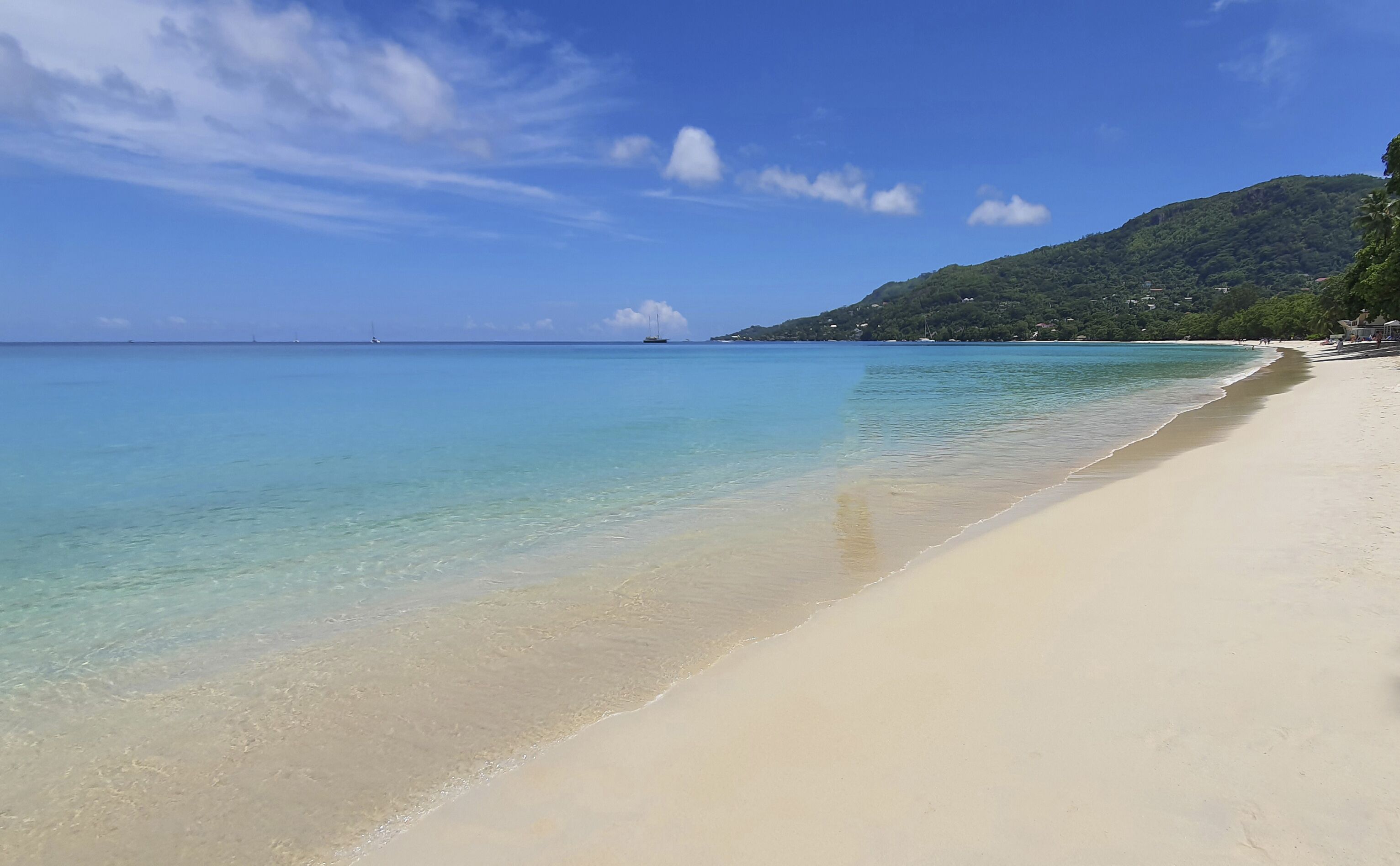 On the beach, white sand, sun-loungers, beach towels