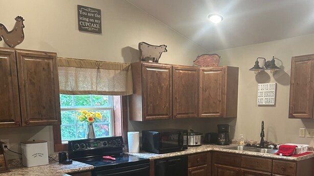 A kitchen with granite countertops, wooden cabinets, a stove, a microwave, and a sink. - Family size Barndo,  Side by Side friendly......Lots of Trails to explore. (Sunbright)