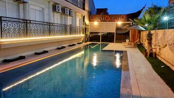 Seasonal outdoor pool, open 8:00 AM to 8:00 PM, pool umbrellas
