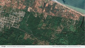 An aerial view of a coastal area with a mix of urban development and natural vegetation. - Amazing & Eco-friendly Beach house (Palomino)