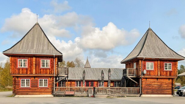 A wooden building with two main structures, each featuring a steeply pitched roof and a central entrance. - 2 bedroom awesome home in Grue Finnskog (Grue Finnskog)