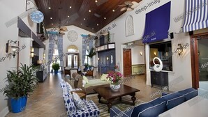 A spacious lobby with a high ceiling, wooden beams, and a central seating area with sofas and a coffee table. - Beautiful Home w/ pool close to Disney Parks  (Kissimmee)