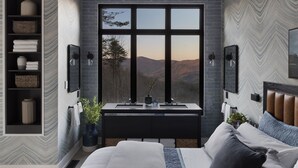 Een moderne slaapkamer met een groot raam, een ingebouwde wastafel en een bed met hoofdeinde.