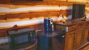 A kitchen with a microwave, toaster, and a television on a wooden countertop. - Farm House Room #10 S (Satin)