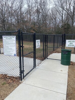 A fenced dog park area with signs indicating separate sections for small and large dogs. - Waterfront Sunsets, Fishing, Boating, and Crabs! Paxs River, Budds Creek MIR. (Maddox)
