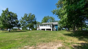 A house with a large lawn and trees.