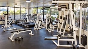 A gym with treadmills, weight machines, and dumbbells. - Amazing view in the beautiful Luana Waikiki! (Honolulu)