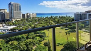 A balcony with a view of a cityscape, including high-rise buildings and a golf course. - Amazing view in the beautiful Luana Waikiki! (Honolulu)