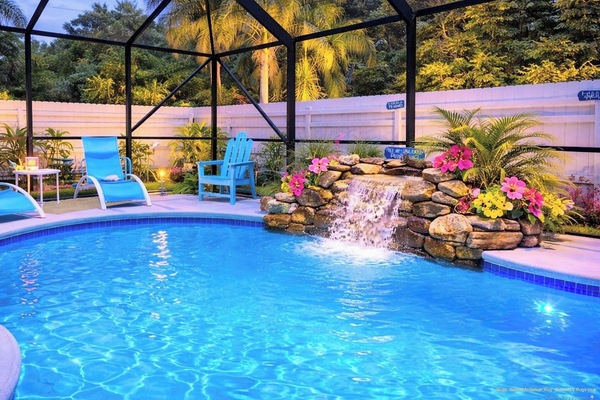 Your private screened oasis — heated saltwater pool, rock waterfall