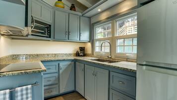 Fridge, microwave, coffee/tea maker, cookware/dishes/utensils