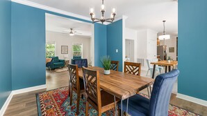 A dining area with a wooden table, blue walls, and a patterned rug. - 3 minutes to Pisgah Forest Entrance! - Game room - Fire pit   (Pisgah Forest)