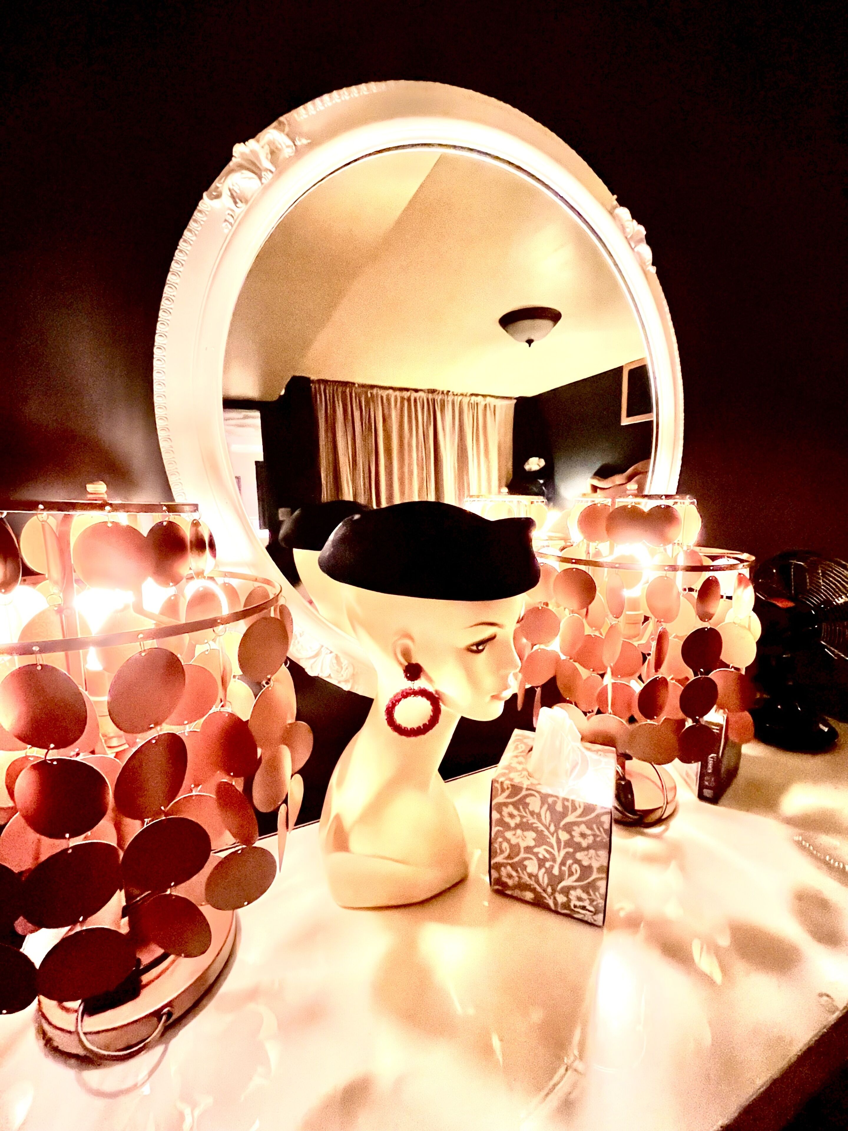 A vanity setup with a large mirror, a makeup table, and a tissue box.