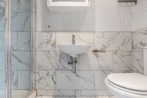 Shower, hair dryer, towels, toilet paper