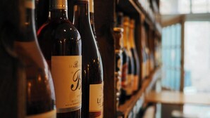 A row of wine bottles on a shelf in a dimly lit room. - Value Studio: Cozy, Kitchenette, Free Wi-Fi (Epernay)