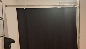 A bathroom with a black shower curtain, a towel rack, and a framed certificate on the wall. - 03 Dutchmen Classic that sleeps 1- 6 people comfortably for the perfect weekend  (Cloquet)