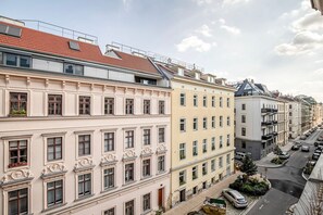 Classic buildings with symmetrical facades and uniform windows, featuring balconies and decorative moldings.