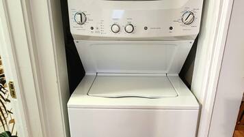 A compact, white front-loading washer and dryer unit with a control panel featuring multiple settings and buttons.
