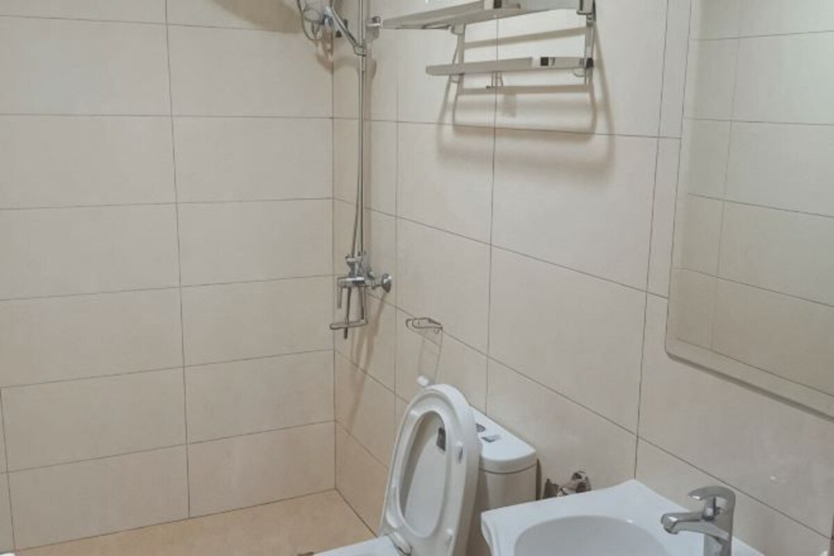 A bathroom with a shower, toilet, and sink.