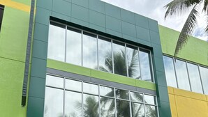 A modern building with a sign reading "Asia Jem Hotel" and a "Grand Opening" banner. - Asia Jem Hotel-Gapan City (Gapan City)