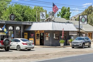 A storefront with a sign for 'DRY GOODS' and a flag. - The Belle Sequoia Motel RM9 (Three Rivers)