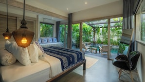 A bedroom with a bed, bedside lamps, a large window, and a view of a pool and garden. - Mundaka Villa by Betterplace (Canggu)
