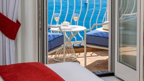 A balcony with a view of the sea, a table with chairs, and a glass of wine. - Villa Francy, Exclusive Villa on the sea with pools (Praiano)