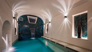 A swimming pool with a herringbone tile pattern, a bench, and a bottle on the right. - Villa Francy, Exclusive Villa on the sea with pools (Praiano)