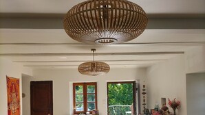A spacious living area with a large window, a wooden door, and a balcony with a railing. - Beau Chalet Rénové, Avec vue Imprenable sur les Montagnes (Dingy-Saint-Clair)
