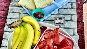 A tray with toast, a cup of coffee, a bowl of jam, bananas, and watermelon slices. - 56 Chiang Mai Soi 3 (Chiang Mai)