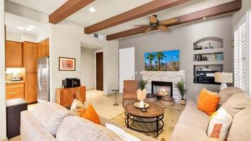 A modern living room with a fireplace, a sofa set, and a coffee table.