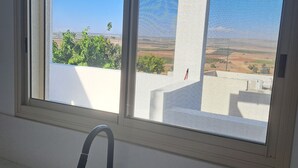 A bathroom with a window, a sink, and a faucet. - Mount Tabor Home by Sea N' Rent (Emek Izrael)